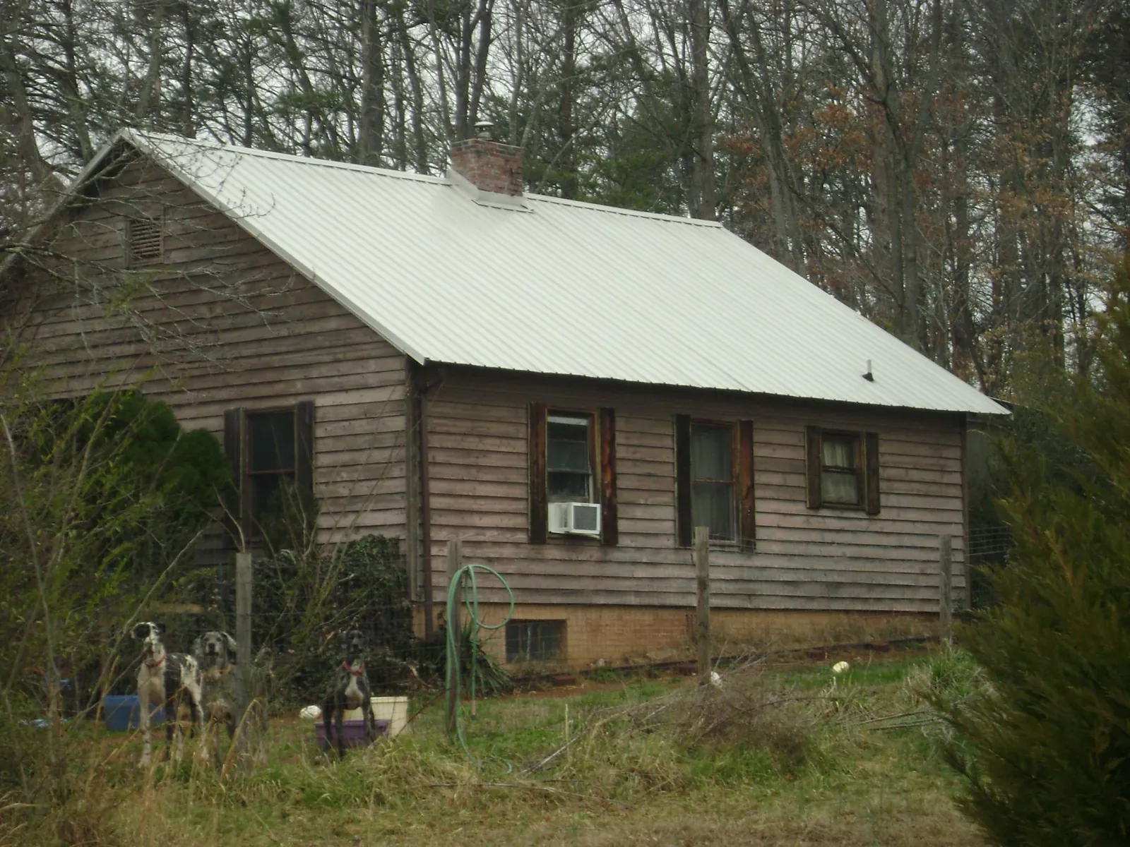 White metal roof on an old wood sided farmhouse, from a Metal Roof Installation job in Pennsville